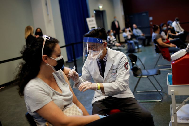 © Reuters. FILE PHOTO: A woman receives a dose of the Johnson & Johnson coronavirus disease (COVID-19) vaccine during a visit of U.S. Vice President Kamala Harris to a vaccination center in Chinatown, in Chicago