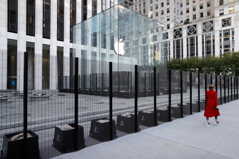 &copy; Reuters. A person walks past a security fence erected around the Apple Fifth Avenue
