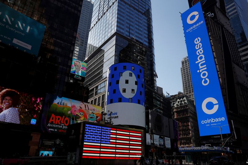 &copy; Reuters. The logo for Coinbase Global Inc is displayed on the Nasdaq MarketSite jumbotron and others at Times Square in New York