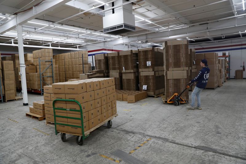 &copy; Reuters. FILE PHOTO: An employee of Defender Safety moves products inside their warehouse in Plainview, New York