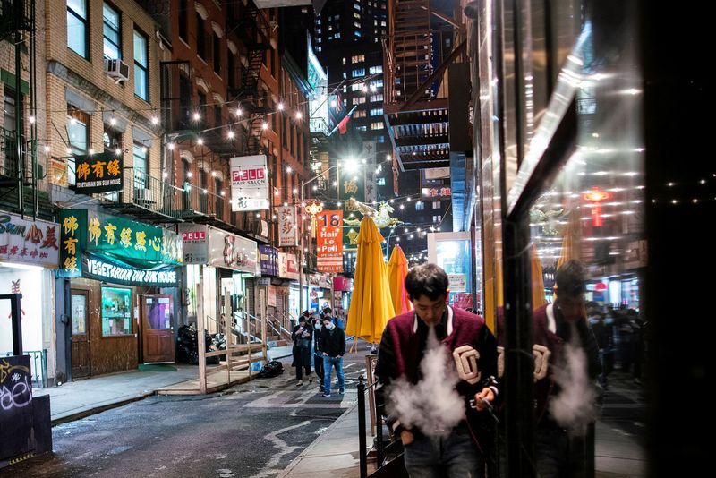 &copy; Reuters. FILE PHOTO: People make their way in a local street of Chinatown in the Manhattan borough of New York