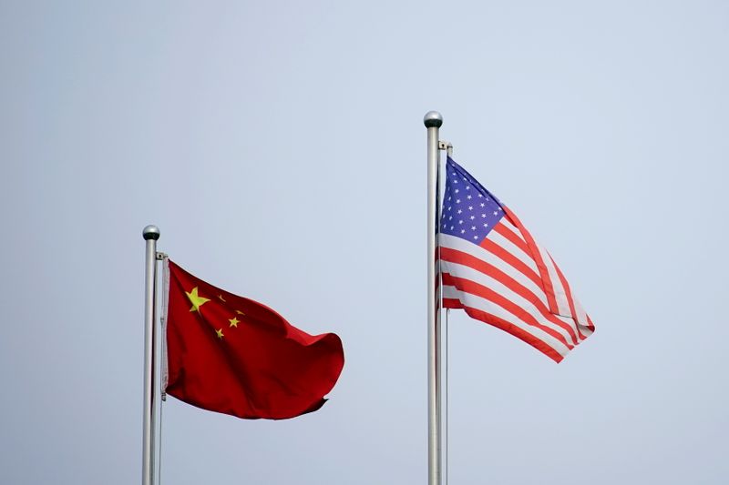&copy; Reuters. Chinese and U.S. flags flutter outside a company building in Shanghai