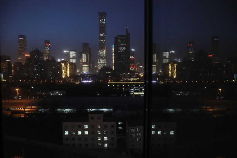 &copy; Reuters. Buildings in the Central Business District (CBD) are seen lit up during the night in Beijing, China April 15, 2021.  REUTERS/Tingshu Wang