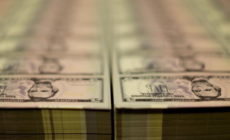 &copy; Reuters. FILE PHOTO: Stacks of Lincoln five dollar bill are seen  at the Bureau of Engraving and Printing in Washington
