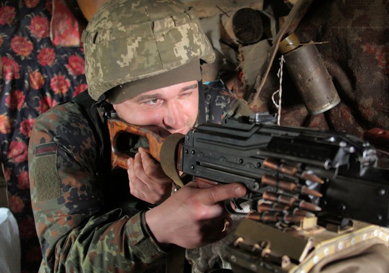 &copy; Reuters. FILE PHOTO: A service member of the Ukrainian armed forces points a weapon at fighting positions on the line of separation near the rebel-controlled city of Donetsk