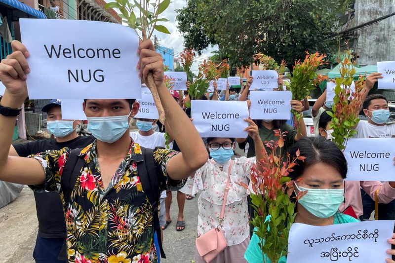 &copy; Reuters. FILE PHOTO: Anti-government protesters hold placards to show their support and welcome the new National Unity Government found by ousted NLD legislators and call to continue strike from traditional new year in Myanmar, in Yangon