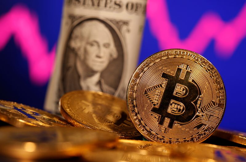 &copy; Reuters. A representation of virtual currency Bitcoin and U.S. One Dollar banknote are seen in front of a stock graph in this illustration