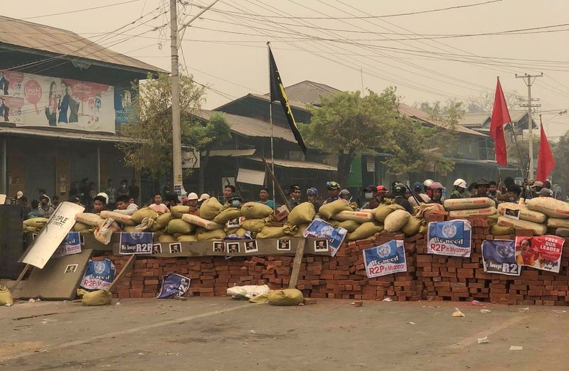 &copy; Reuters. Protesters defend themselves from the troops in Kale, Sagaing region