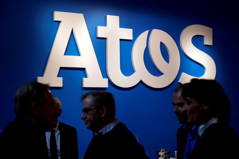 &copy; Reuters. FILE PHOTO: FILE PHOTO: People walk in front of the Atos company&apos;s logo during a presentation of the new Bull sequana supercomputer in Paris
