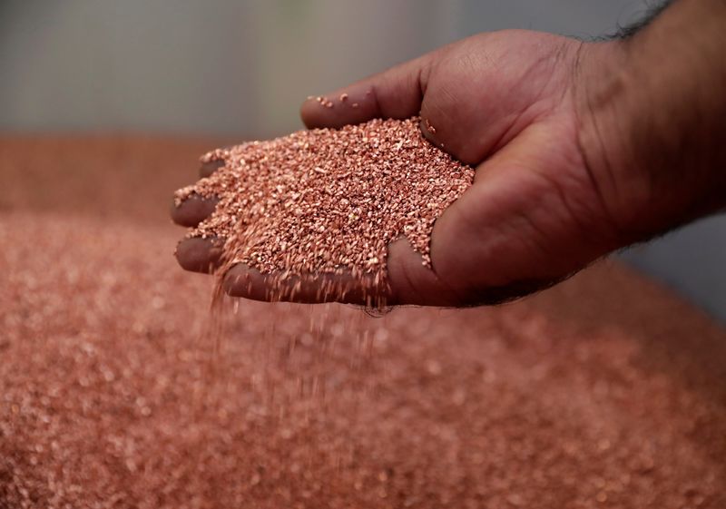 &copy; Reuters. An employee holds copper granules at the Loacker Swiss Recycling AG company in Birmensdorf
