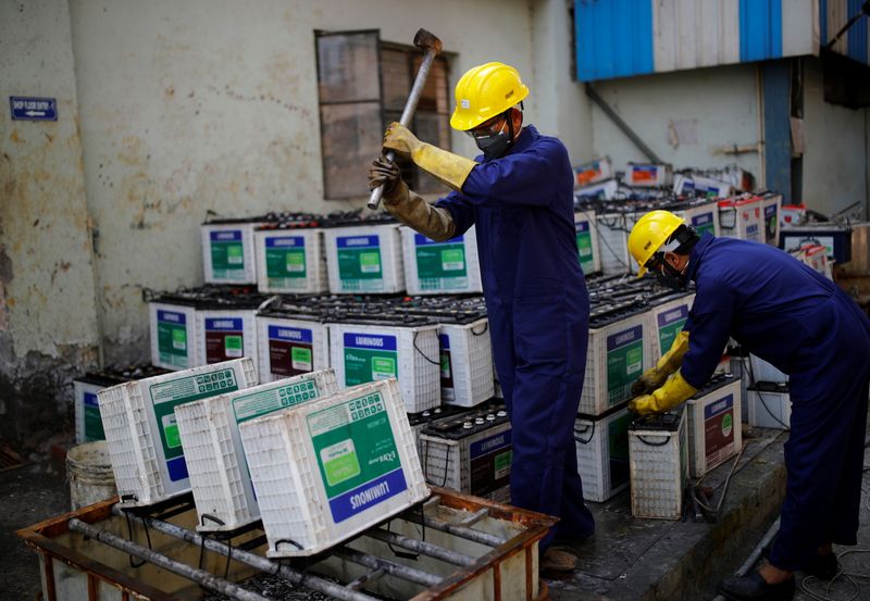 &copy; Reuters. Workers dismantle batteries to obtain lead from them at ACE Green recycling Inc in Ghaziabad