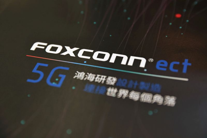 © Reuters. FILE PHOTO: A poster with a logo of Foxconn is seen at the IEEE Global Communications Conference in Taipei