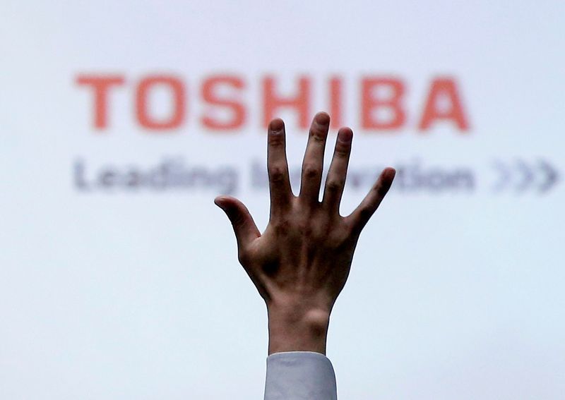 &copy; Reuters. FILE PHOTO: A reporter raises his hand for a question during a news conference by Toshiba Corp CEO Satoshi Tsunakawa at the company headquarters in Tokyo