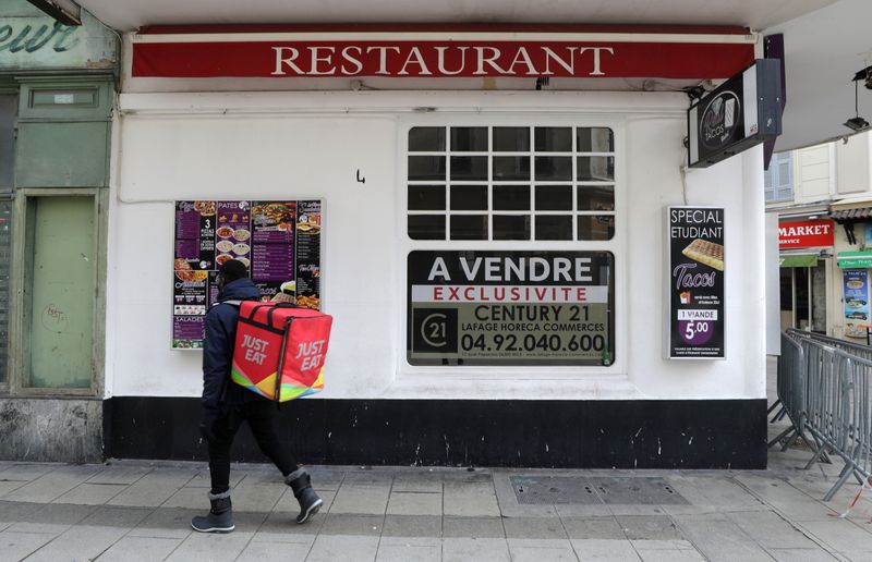 &copy; Reuters. A Just Eat delivery man stands in front of a closed restaurant on sale in Nice