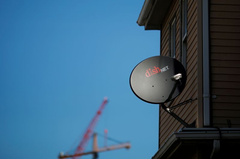 &copy; Reuters. FILE PHOTO: A Dish Network receiver hangs on a house in Somerville