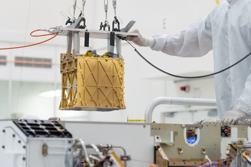 &copy; Reuters. Technicians at NASA&apos;s Jet Propulsion Laboratory lower the Mars Oxygen In-Situ Resource Utilization Experiment (MOXIE) instrument into the belly of the Perseverance rover