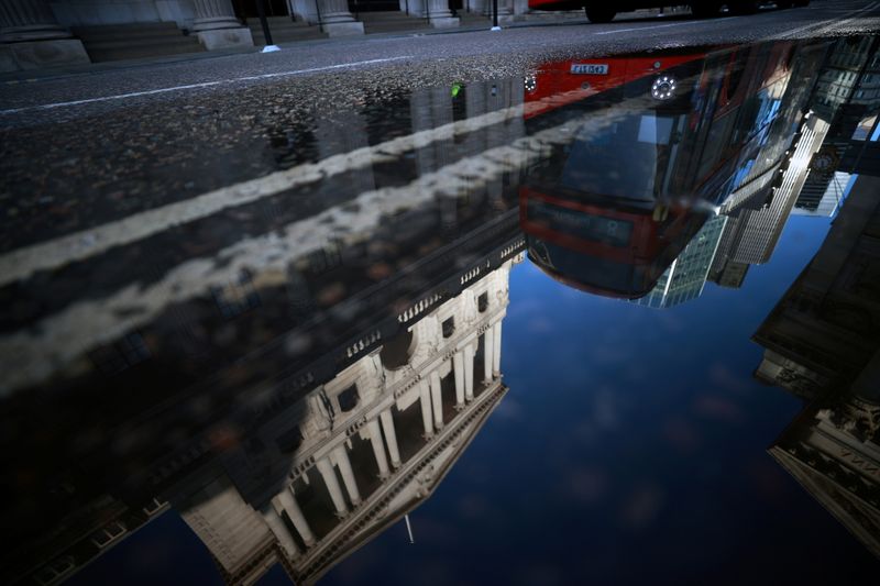 &copy; Reuters. FILE PHOTO: The Bank of England and the City of London financial district are reflected in a puddle, in London