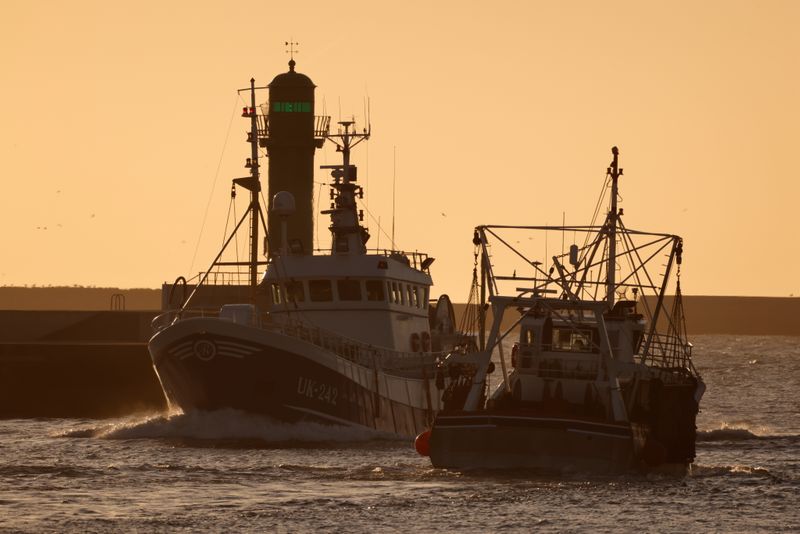 &copy; Reuters. Trawlers are seen in the fishing port during sunset in Boulogne-sur-Mer