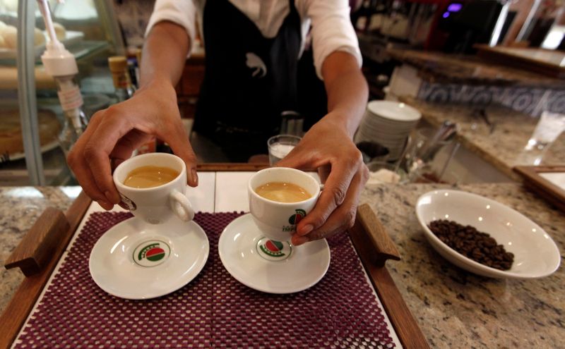 &copy; Reuters. Garçom serve clientes em uma cafeteria em São Paulo; consumo da bebida tem se firme pelo mundo apesar da pandemia