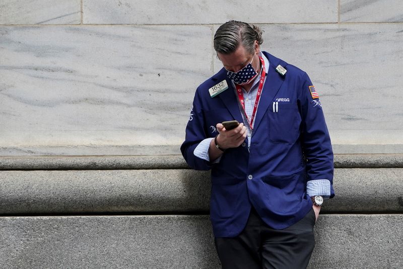 &copy; Reuters. A trader takes a break outside the New York Stock Exchange in New York