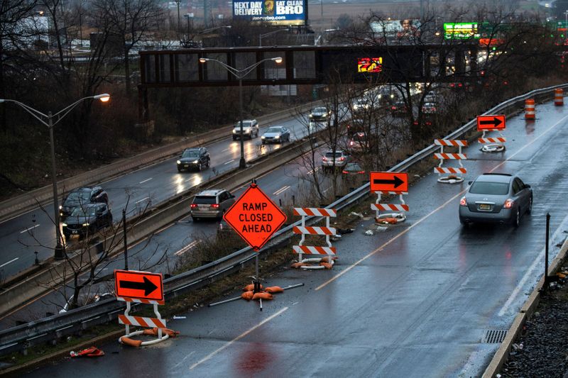 &copy; Reuters. Cars drive along the NJ 495 route while road work signs are seen on the roadside, in Union City