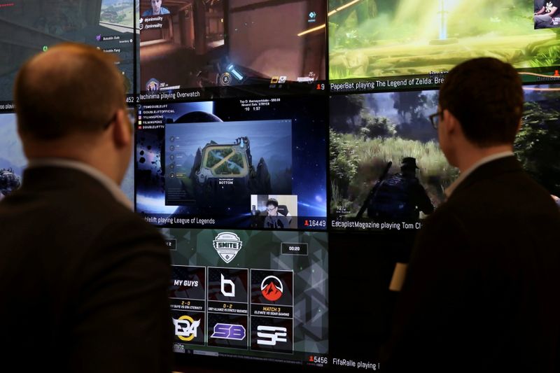 &copy; Reuters. FILE PHOTO: Men look at a wall of real-time video game play in the lobby of Twitch Interactive Inc, a social video platform and gaming community owned by Amazon, in San Francisco, California