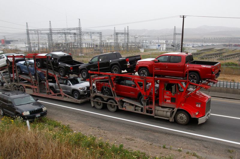 &copy; Reuters. A carrier trailer transports Toyota cars for delivery while queuing at the border customs control to cross into the U.S.