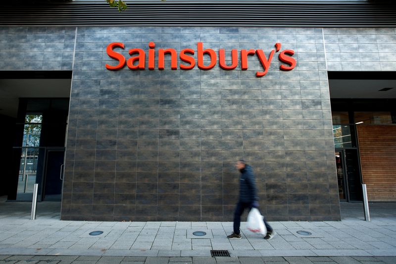&copy; Reuters. FILE PHOTO: A person walks past a Sainsbury&apos;s store in Milton Keynes