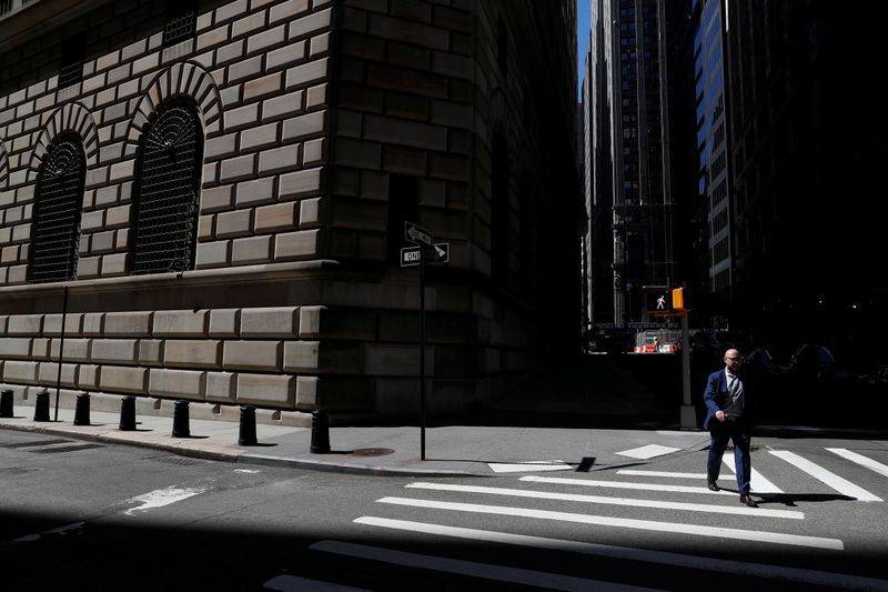 &copy; Reuters. A man walks by the Federal Reserve Bank of New York Building in New York City