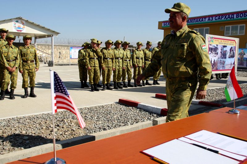 &copy; Reuters. Tajik servicemen take part in a ceremony opening the &quot;Okmazor&quot; frontier post in Hamadoni district