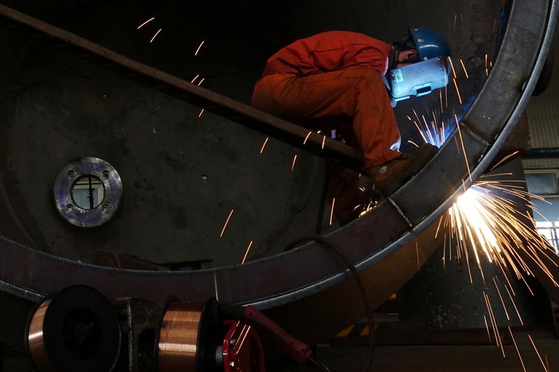 &copy; Reuters. Worker of Dongbei Special Steel welds a steel structure at a plant in Dalia