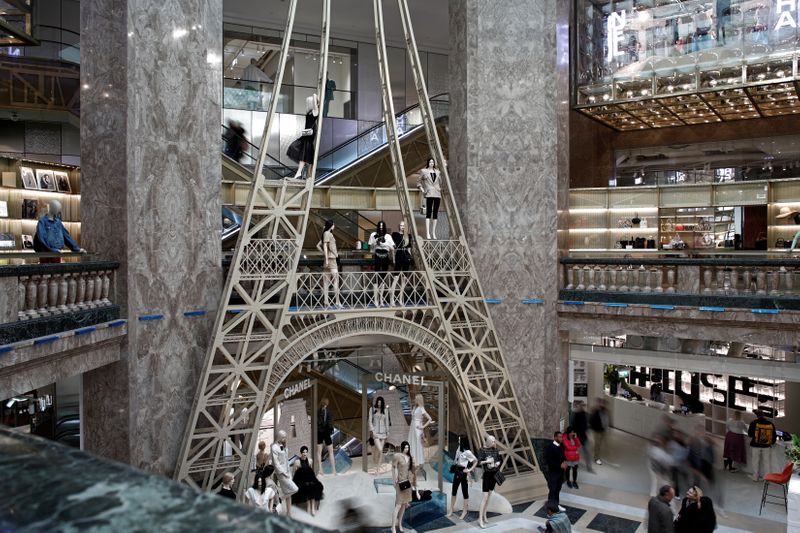 &copy; Reuters. Shoppers browse as Chanel luxury corner sales stand sits on the ground floor of the Galeries Lafayette department store on the Champs-Elysees avenue in Paris