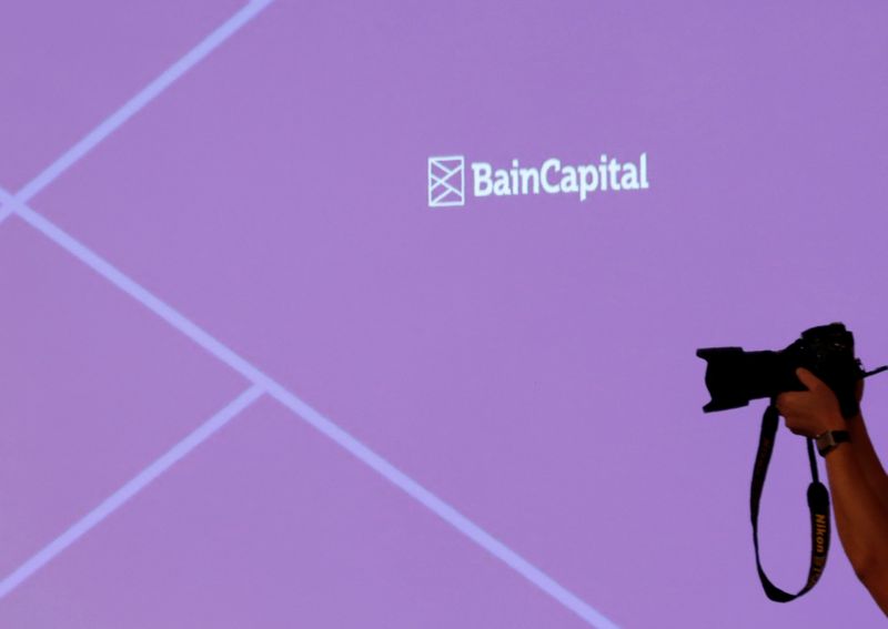 &copy; Reuters. The logo of Bain Capital is displayed on the screen during a news conference in Tokyo