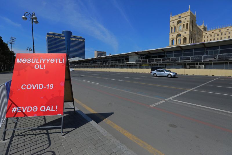 &copy; Reuters. A coronavirus warning sign is seen near the racing track of Formula One Azerbaijan Grand Prix in Baku