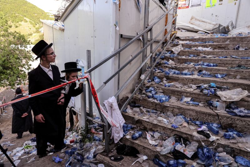 &copy; Reuters. Ultra Orthodox Jews look at stairs with waste on it in Mount Meron