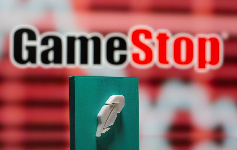 &copy; Reuters. A 3d printed Robinhood logo is seen in front of displayed GameStop logo in this illustration