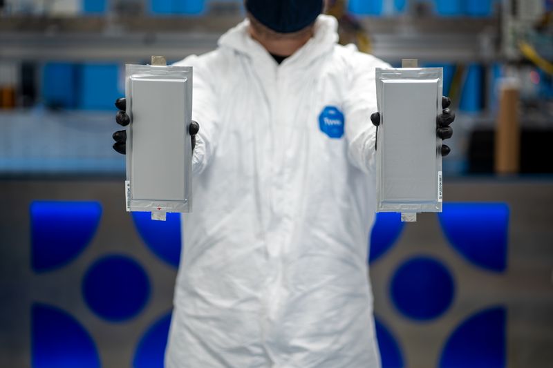 &copy; Reuters. A Solid Power manufacturing engineer holds two 20 ampere hour (Ah) all solid-state battery cells for the BMW Group and Ford Motor Company