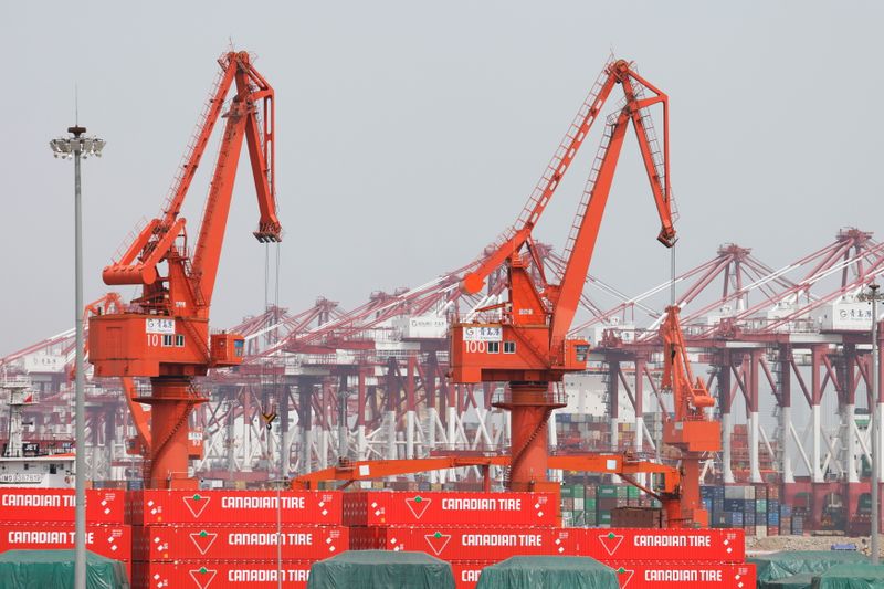 © Reuters. Canadian Tire containers are seen near cranes at Qingdao port