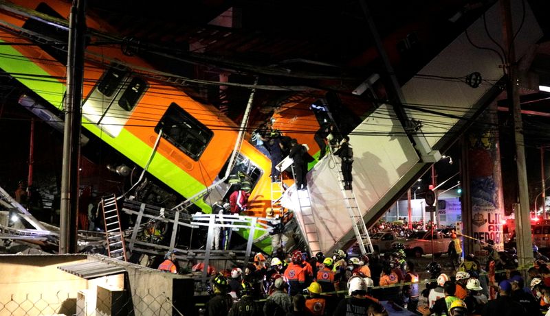 &copy; Reuters. Rescuers work at a site where an overpass for a metro partially collapsed with train cars on it at Olivos station in Mexico City