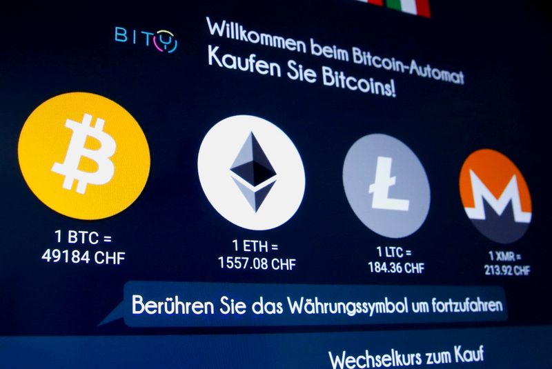 &copy; Reuters. FILE PHOTO: The exchange rates and logos of Bitcoin (BTH), Ether (ETH), Litecoin (LTC) and Monero (XMR) are seen on the display of a cryptocurrency ATM of blockchain payment service provider Bity at the House of Satochi bitcoin and blockchain shop in Zuri