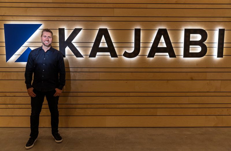 &copy; Reuters. FILE PHOTO: Kenny Rueter, CEO of Kajabi poses by the company's office logo in Irvine, California, U.S., November 2020 in this handout image obtained by Reuters on May 3, 2021.  Courtesy of Kajabi/Handout via REUTERS 
