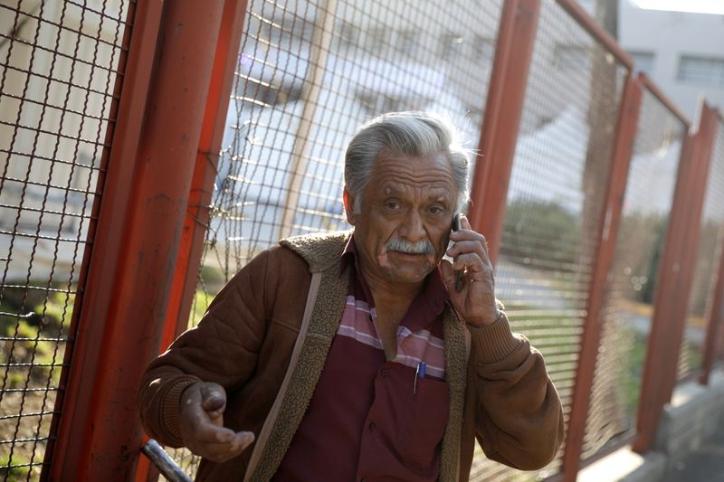 &copy; Reuters. Jorge Hernandez speaks on the phone while waiting for news about his 28-year-old nephew Daniel, who had been seriously injured during the accident where an overpass of a metro partially collapsed with train cars on it, outside a hospital in Mexico City, M