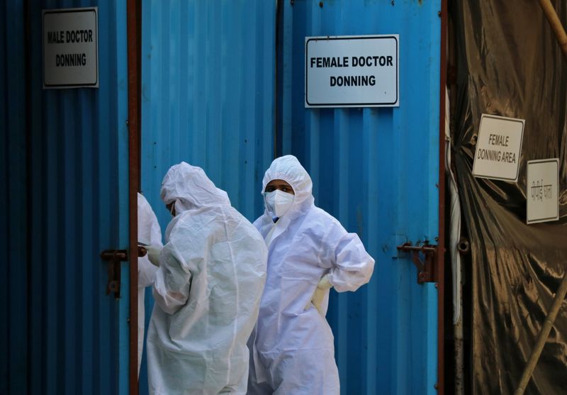 &copy; Reuters. FILE PHOTO: Healthcare workers wearing personal protective equipment (PPE) stand outside a donning area at a COVID-19 care facility, amidst the spread of the coronavirus disease (COVID-19) in Mumbai, India, May 4, 2021. REUTERS/Niharika Kulkarni