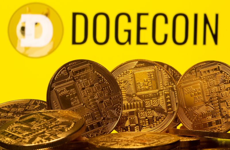 &copy; Reuters. FILE PHOTO: Cryptocurrency representations are seen in front of the Dogecoin logo in this illustration picture taken April 20, 2021. REUTERS/Dado Ruvic/Illustration
