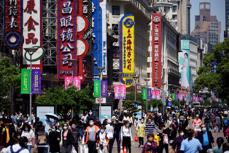 &copy; Reuters. People walk along Nanjing Pedestrian Road during the Labour Day holiday in Shanghai