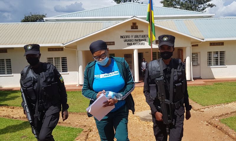 &copy; Reuters. Beatrice Munyenyezi, who was deported by the U.S., is escorted as she leaves court, facing charges related to the 1994 genocide, in Kigali