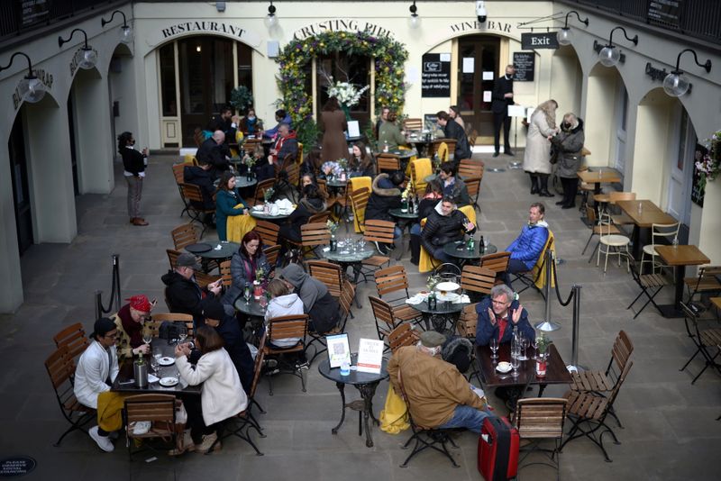&copy; Reuters. FILE PHOTO: People sit at outside restaurant area, as the coronavirus disease (COVID-19) restrictions ease, at Covent Garden in London, Britain April 12, 2021. REUTERS/Henry Nicholls