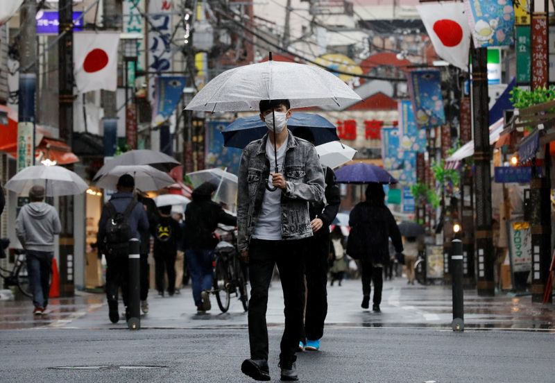 &copy; Reuters. A man walks at a local shopping street in Tokyo