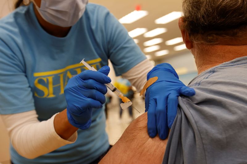 &copy; Reuters. FILE PHOTO: Nursing student Erika Lohr vaccinates a patient as California opens up vaccine eligibility to any residents 16 years and older during the outbreak of coronavirus disease (COVID-19) in Chula Vista, California, U.S., April 15, 2021.  REUTERS/Mik