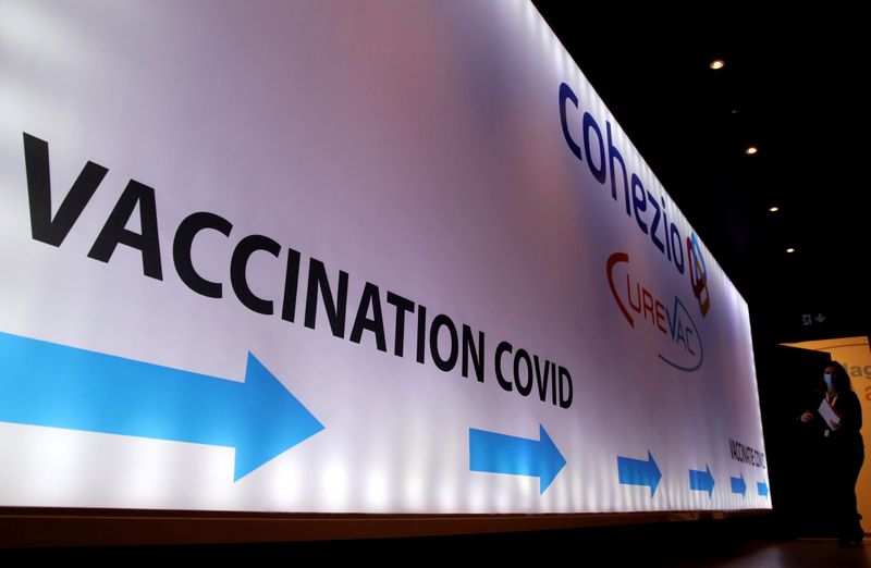 &copy; Reuters. FILE PHOTO: Woman walks past a board in a testing center for the CureVac vaccine during a study in Brussels